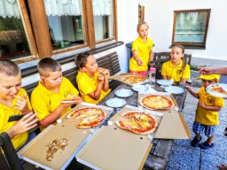 Eating lunch pizza in camp-home (Arzl im Pitztal, Austria)
